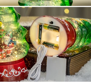 Detail showing the battery compartment and USB power options for the Christmas tree snow globe