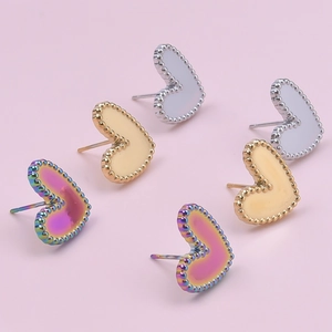 Detail of heart-shaped stainless steel stud earrings with beaded edge in three colors