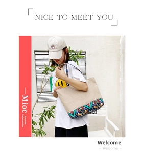 Detail of a large canvas tote bag with colorful geometric ethnic print and sturdy handles