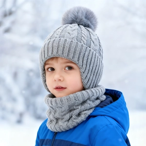 Detailed cable knit texture and faux fur pom-pom on toddler winter hat and scarf set