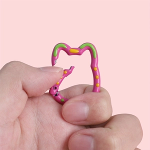 Detail of rose red cat-shaped carabiner showing the snap hook mechanism and paint finish