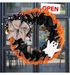 Macro shot of Halloween burlap wreath with BOO ribbons and white wooden ghost decor