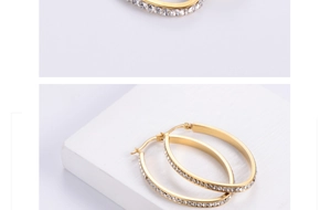 Detailed close-up of gold 18K titanium steel oval earrings with shimmering rhinestones
