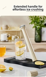 Detail of cream-colored ice muddler with long handle and 500ml graduated measuring cup