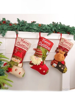 Detailed view of three 3D Christmas stockings featuring Santa, Snowman and Reindeer