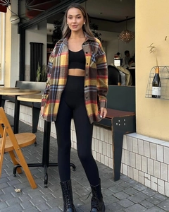 Outdoor shot of a vintage plaid wool shirt in yellow and red tones with a thick texture