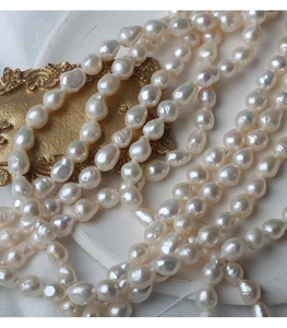 Macro shot of 6.5-7mm irregular baroque pearls with glossy finish on a white plate