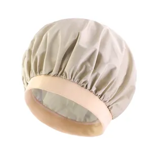 Detail of elastic pink knit band and beige satin waterproof sleep cap with fine stitching