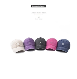 Detailed row of washed cotton baseball caps in five colors with embroidered U logo