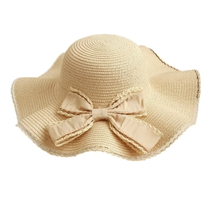 Women's light beige woven straw sun hat with large wavy brim and elegant bow detail
