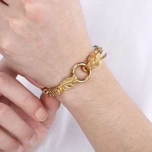 Classic gold dragon head chain bracelet for men with round buckle on white fabric background