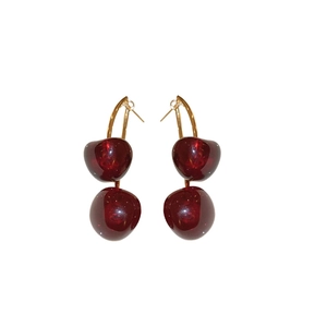 Minimalist dark red resin cherry earrings with golden hooks on white background