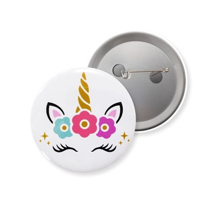 Front and back detail of a unicorn tinplate badge with safety pin and floral pattern