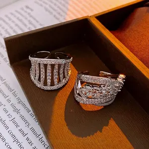 Hollow zircons open rings with crown design and layered leaf patterns in silver