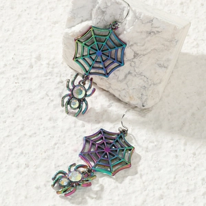 Close-up of spider web earrings with iridescent rainbow plating and sparkling rhinestones
