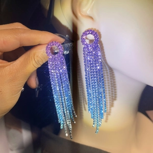 Detailed macro view of purple to blue gradient rhinestone fringe tassel earrings on model