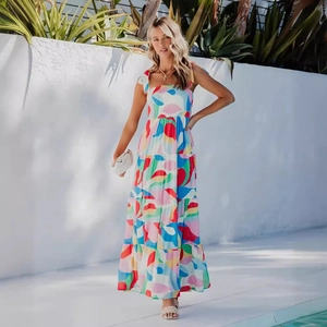 Bohemian floral maxi dress with halter neck and tiered skirt on a vacation background