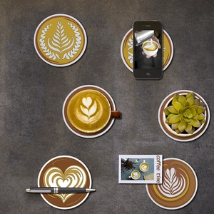 Detailed top view of heat-resistant round coasters with latte art patterns on stone surface