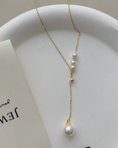 Detail view of S925 silver Y-shaped tassel necklace with gold chain and white pearls