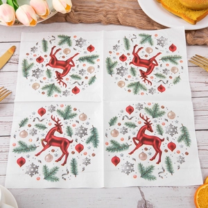 Christmas printed napkins with reindeer and snowflake pattern on festive wooden table