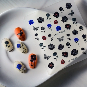 Detailed macro view of 5D embossed nail art stickers with 3D floral and butterfly patterns