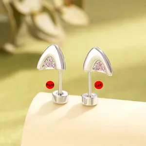 Cat ear titanium steel studs with pink zircon stones on a cream display stand