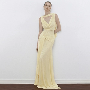 Detail of elegant backless pale yellow maxi dress featuring mesh splicing and tie details