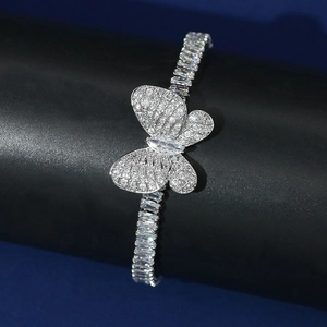 Macro shot of silver butterfly bracelet with pave stones on a black velvet stand