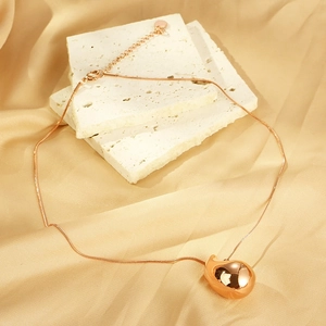 Fashionable rose gold hollow water drop pendant necklace on elegant beige stone props