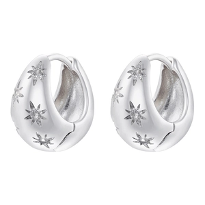 Detail of silver hoop earrings with star engravings and inlaid cubic zirconia crystals