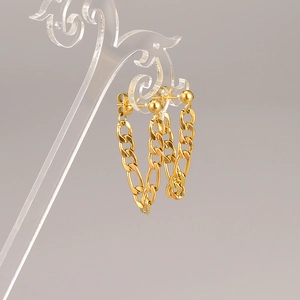 Polished gold Cuban link chain drop earrings displayed on a clear acrylic holder stand