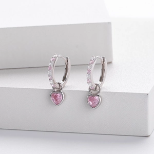 Macro shot of S925 sterling silver hoop earrings with pink heart shaped zircon charms