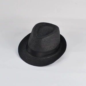 Detailed view of black paper straw fedora hat featuring woven texture and satin ribbon