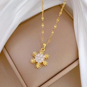 Macro shot of spinning hollow snowflake necklace with gold chain and clear cubic zirconia