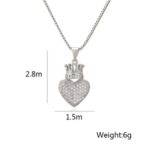 Detailed view of silver heart crown pendant with sparkling cubic zirconia on a box chain