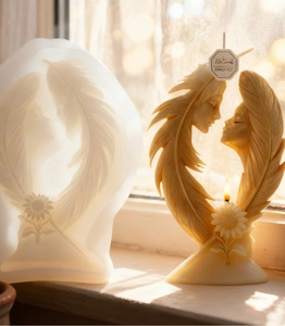 Detailed silicone mold and finished candle showing faces embraced by feathers and sunflowers