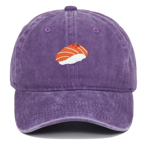 Detail of sushi embroidery on washed purple cotton baseball cap with vintage texture