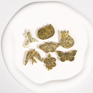 Détails de gravure sur broches en métal doré vintage avec motifs animaux et floraux