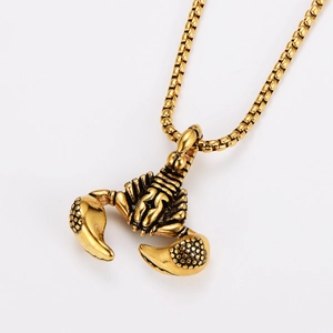 Detailed close-up of a gold scorpion pendant necklace with textured vintage metal finish
