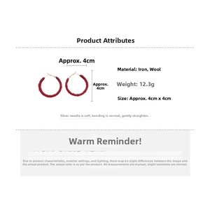 Detail view of red flocked hoop earrings with size 4x4cm and golden hooks on white background