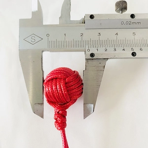 Handmade red monkey fist knot keychain, 24mm diameter measured with a caliper