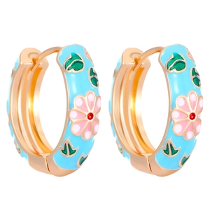 Close-up of blue enamel hoop earrings with pink flower patterns and gold-tone finish