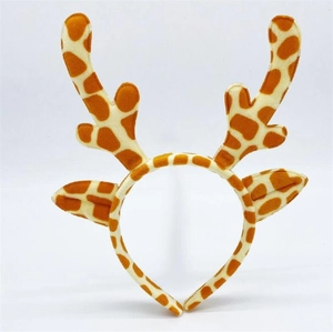 Detail of plush Christmas reindeer headband featuring giraffe pattern antlers and cute ears