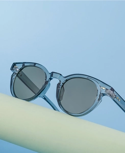 Close-up of blue translucent frames with distinct metal arrow and star rivet details
