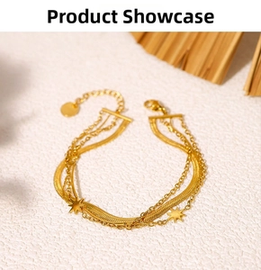 Detail of 18K gold-plated stainless steel layered bracelets with star pendants and snake chain