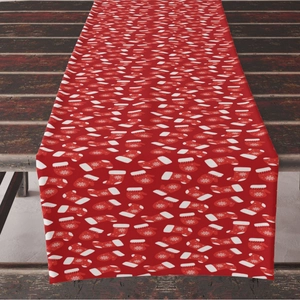 Red Christmas table runner with white sock patterns on vintage dark wooden tabletop