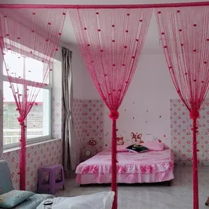 Detail of pink rose string curtain with floral tassels for room dividers and decor