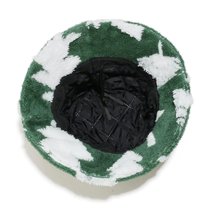 Detail view of the plush Christmas tree bucket hat with black quilted lining and adjustable cord