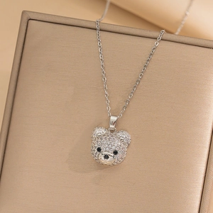 Macro shot of silver teddy bear pendant with sparkling cubic zirconia pavé and fine chain