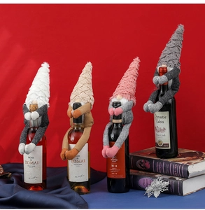 Detail of Christmas gnome wine bottle covers in pink, grey, white and beige knit fabric